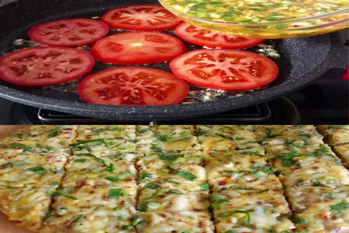 Freshly cooked tomato slices in a pan with a mixture of scrambled eggs, green onions, and melted cheese being poured over them.